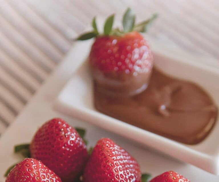 A cake with fruit on a plate, with Chocolate