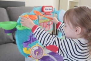 A small child playing with STEM toy