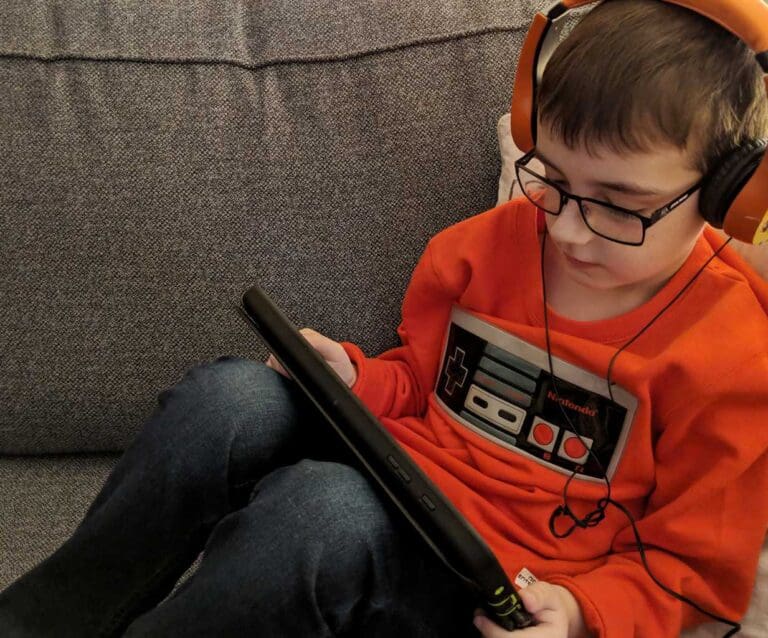 A boy sitting and looking at the camera