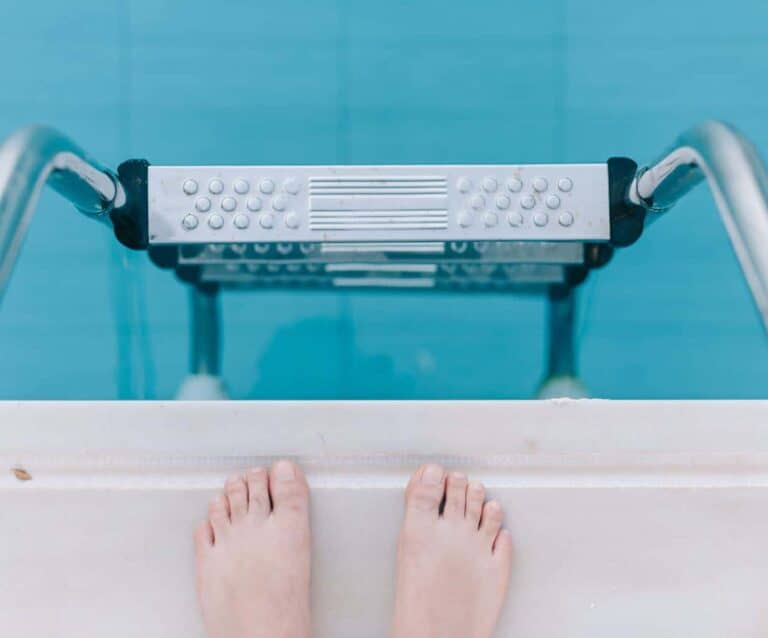 A close up of pink tub and sink