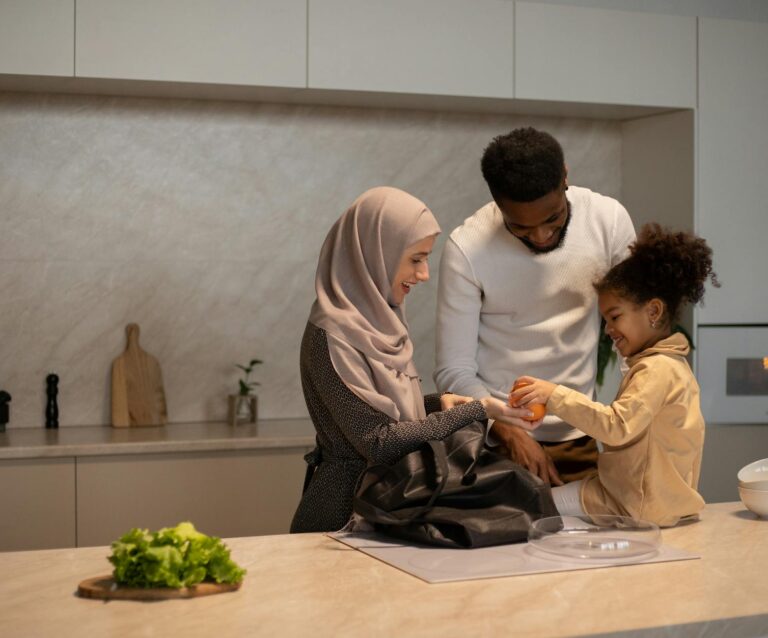 happy multiethnic family near table in kitchen