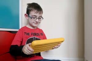 A young boy holding a banana