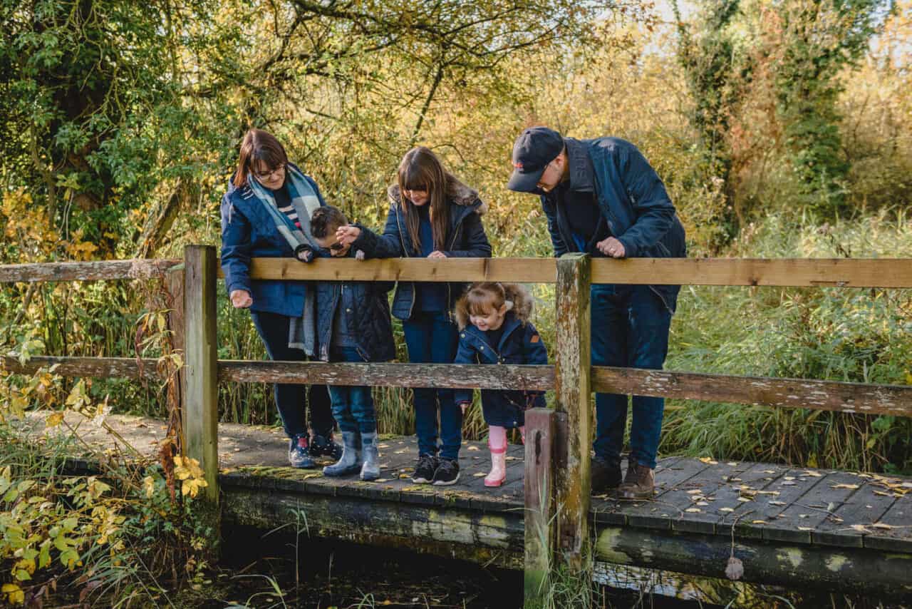 A group of people sitting on a wooden bench