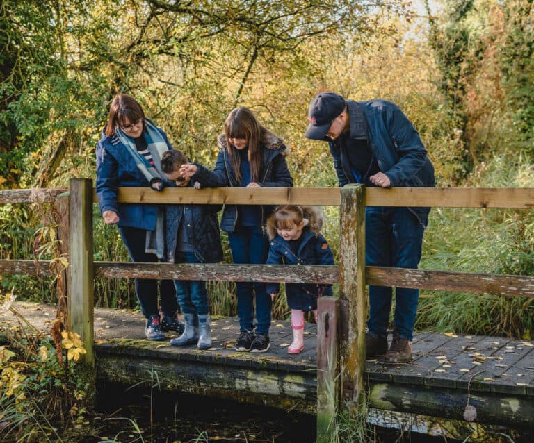 A group of people sitting on a wooden bench