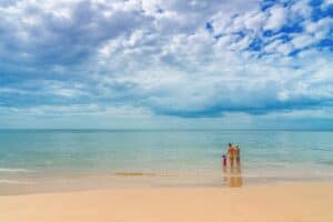 A person sitting on top of a sandy beach