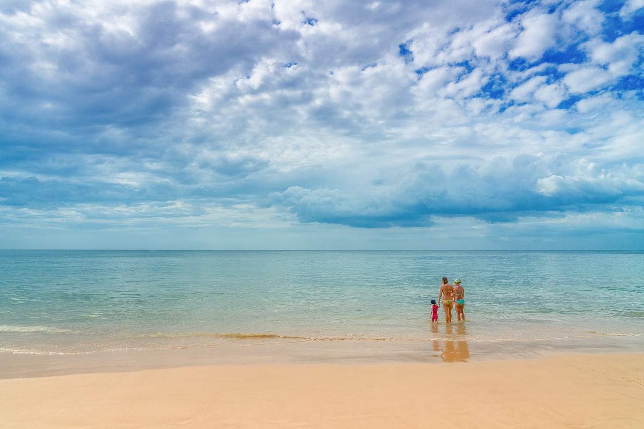 A person sitting on top of a sandy beach