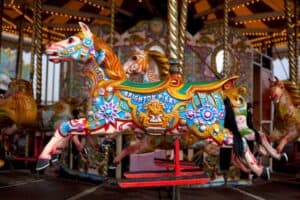 A person standing in front of a carousel