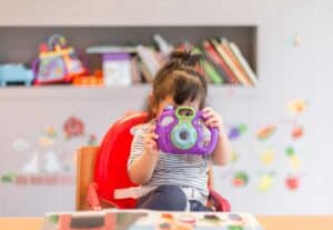 A little girl sitting on a table