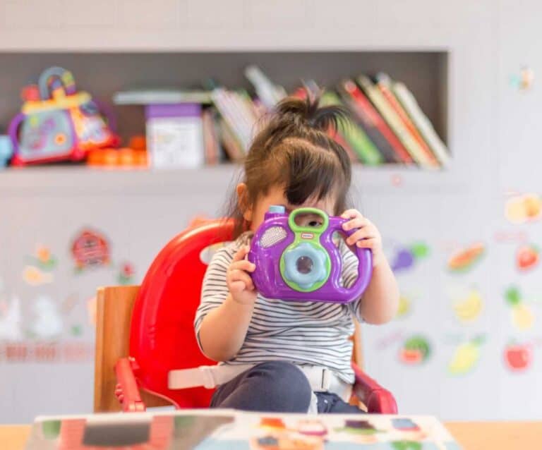 A little girl sitting on a table