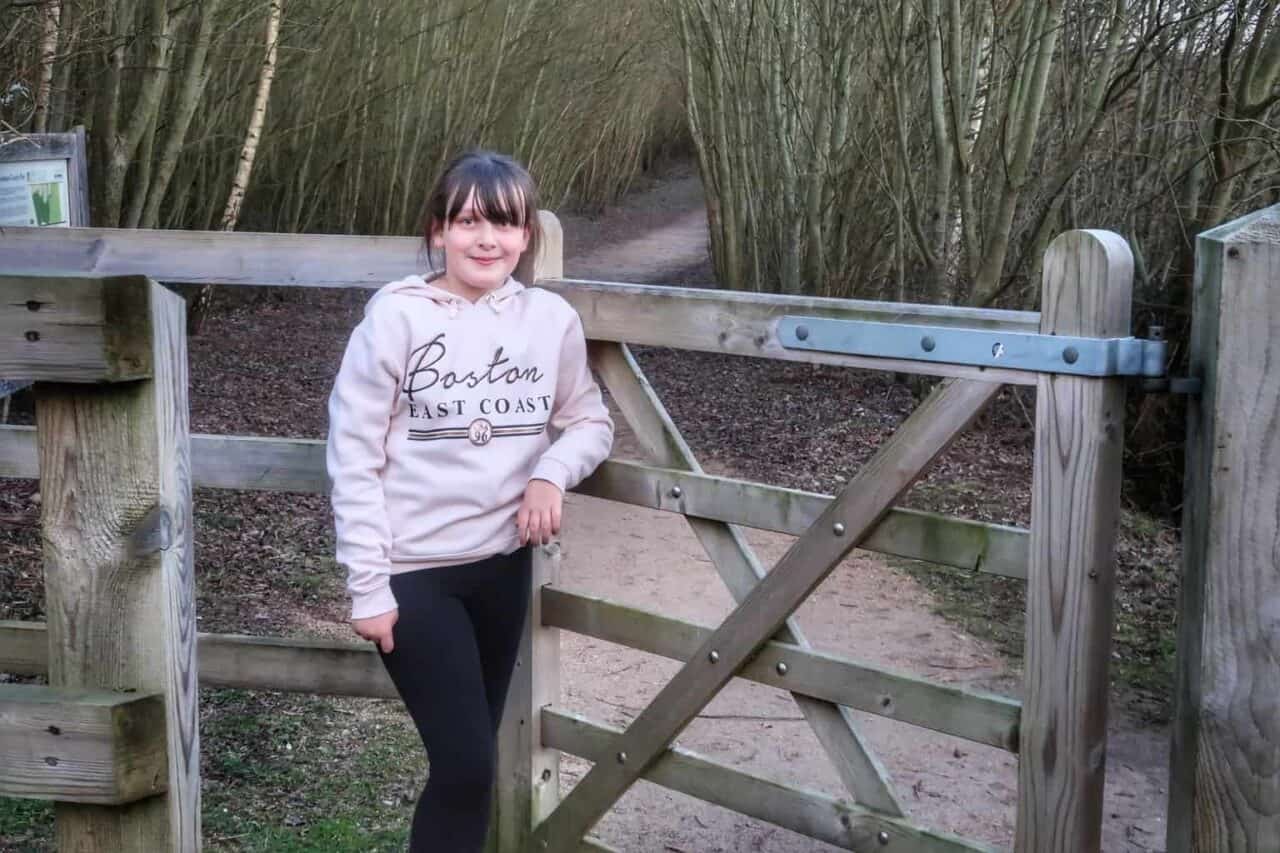 A person sitting on a bench posing for the camera