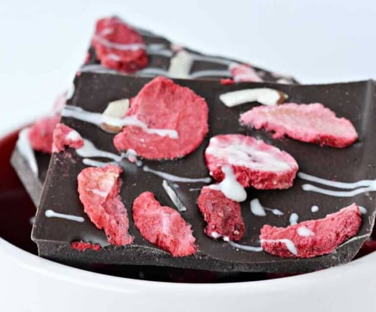 A piece of chocolate cake on a plate, with Strawberry