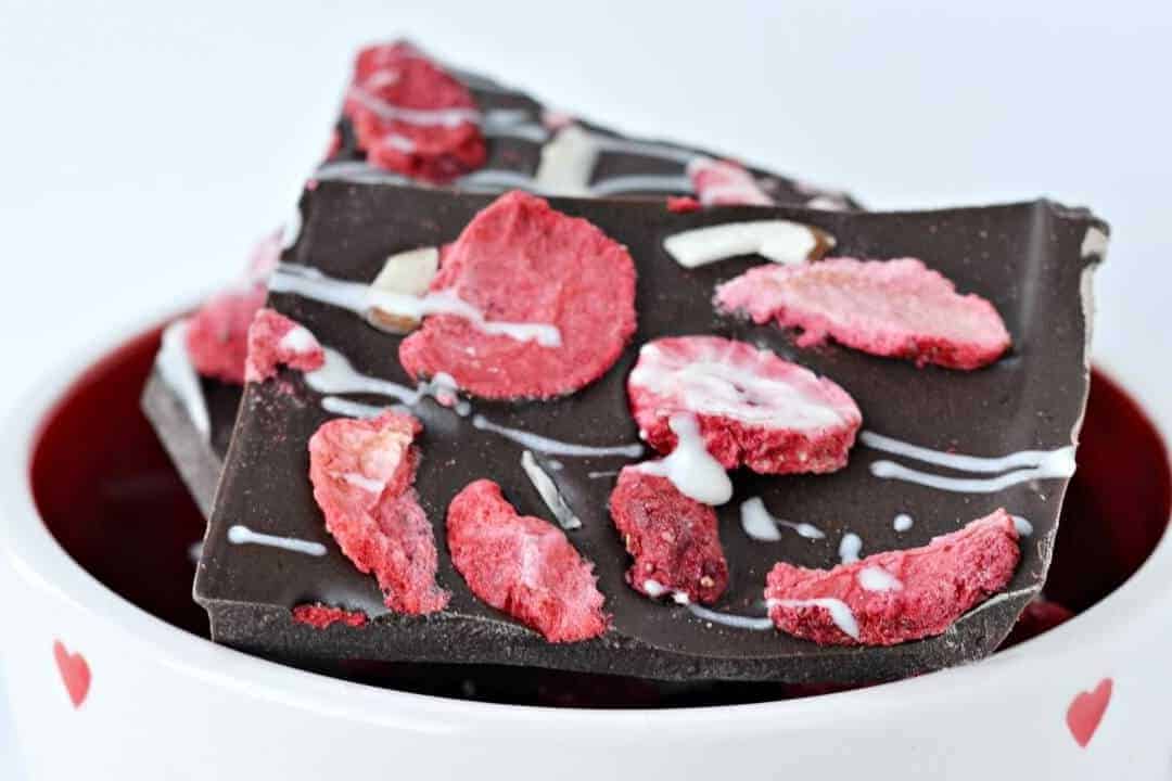 A piece of chocolate cake on a plate, with Strawberry