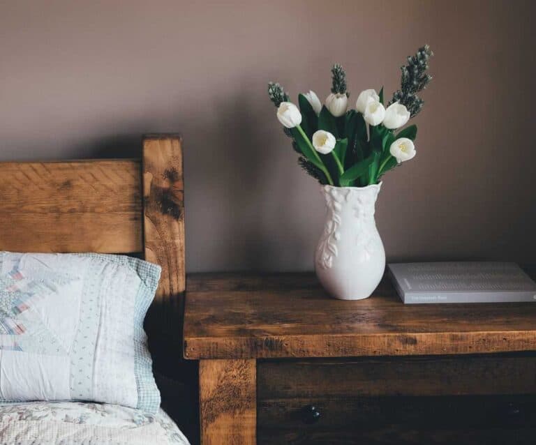 A vase of flowers sitting on top of a wooden table