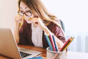 A girl sitting at a table using a laptop