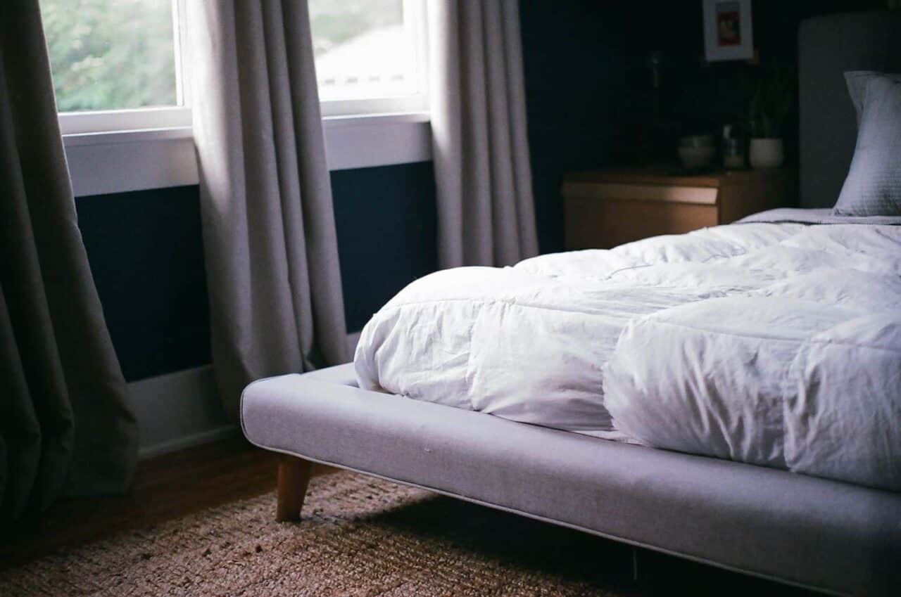 A large bed sitting next to a window