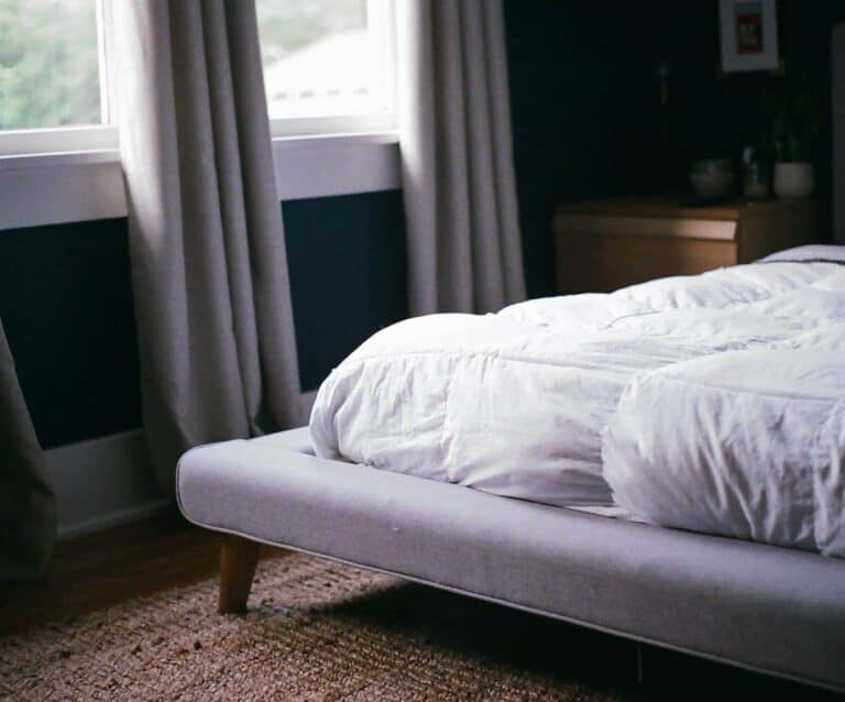 A large bed sitting next to a window