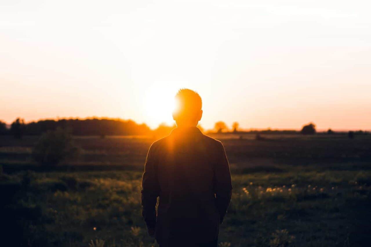 A man with a sunset in the background