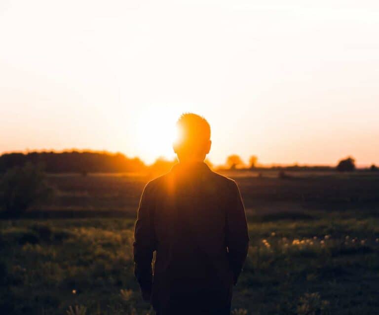 A man with a sunset in the background