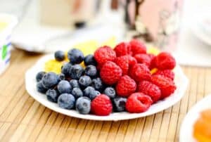 A close up of a cake with fruit on a plate