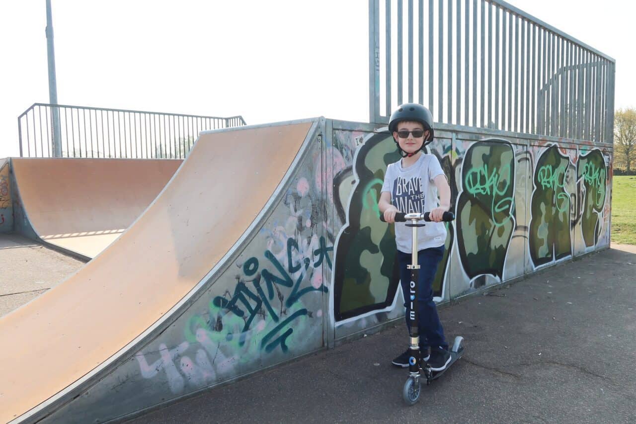 A young boy riding a skate board at a skate park