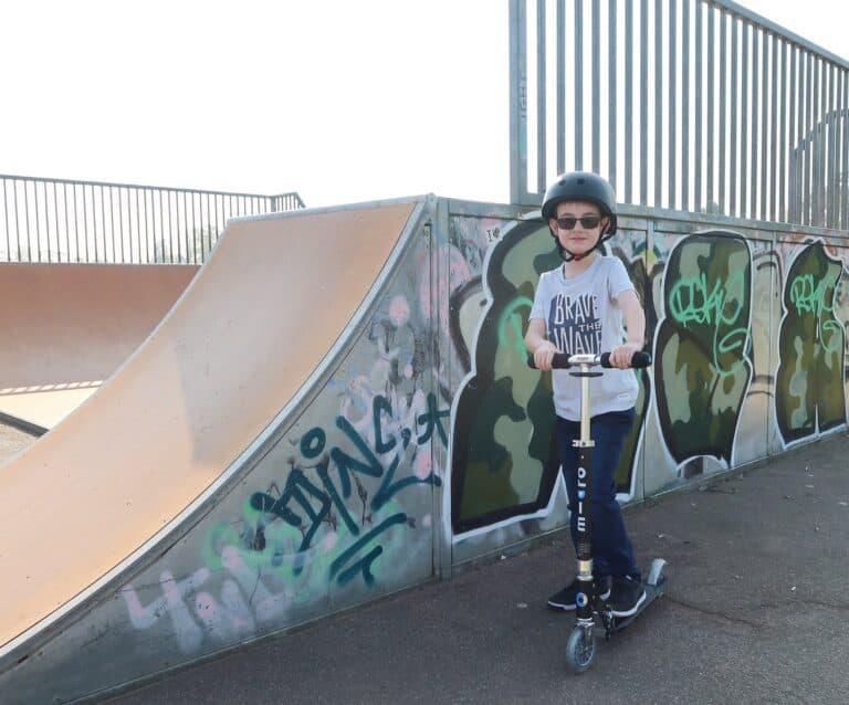 A young boy riding a skate board at a skate park