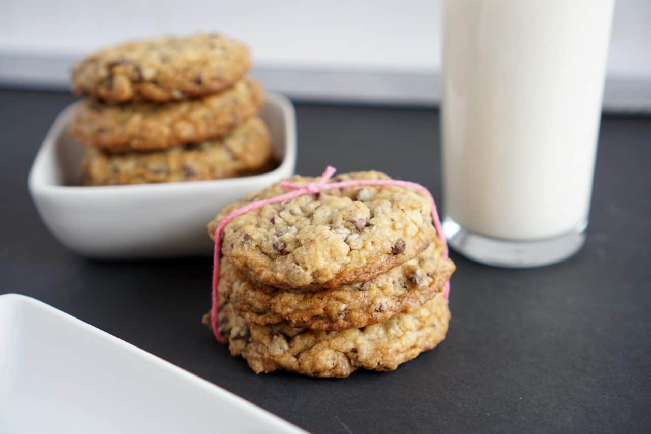 A close up of a plate of food and a cup of coffee, with Cookie and Oatmeal