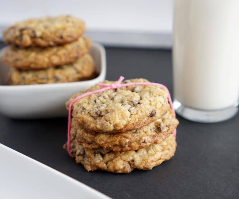 A close up of a plate of food and a cup of coffee, with Cookie and Oatmeal