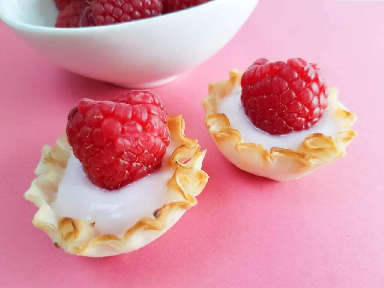 A piece of fruit on a plate, with Berry and Raspberry