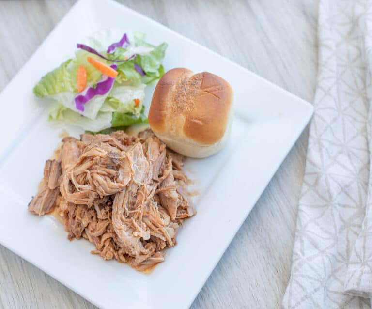 A plate of food on a table, with Pork and Pulled pork