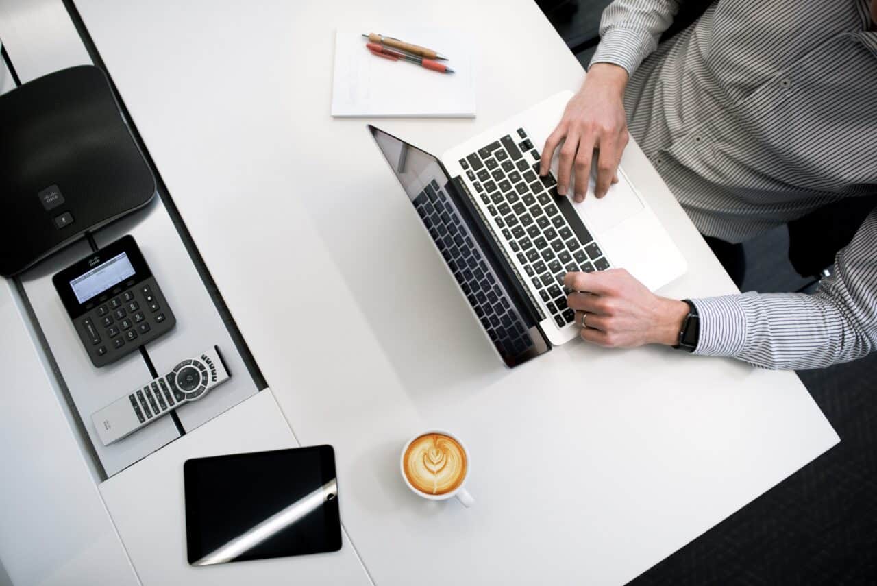 A person sitting in front of a laptop computer