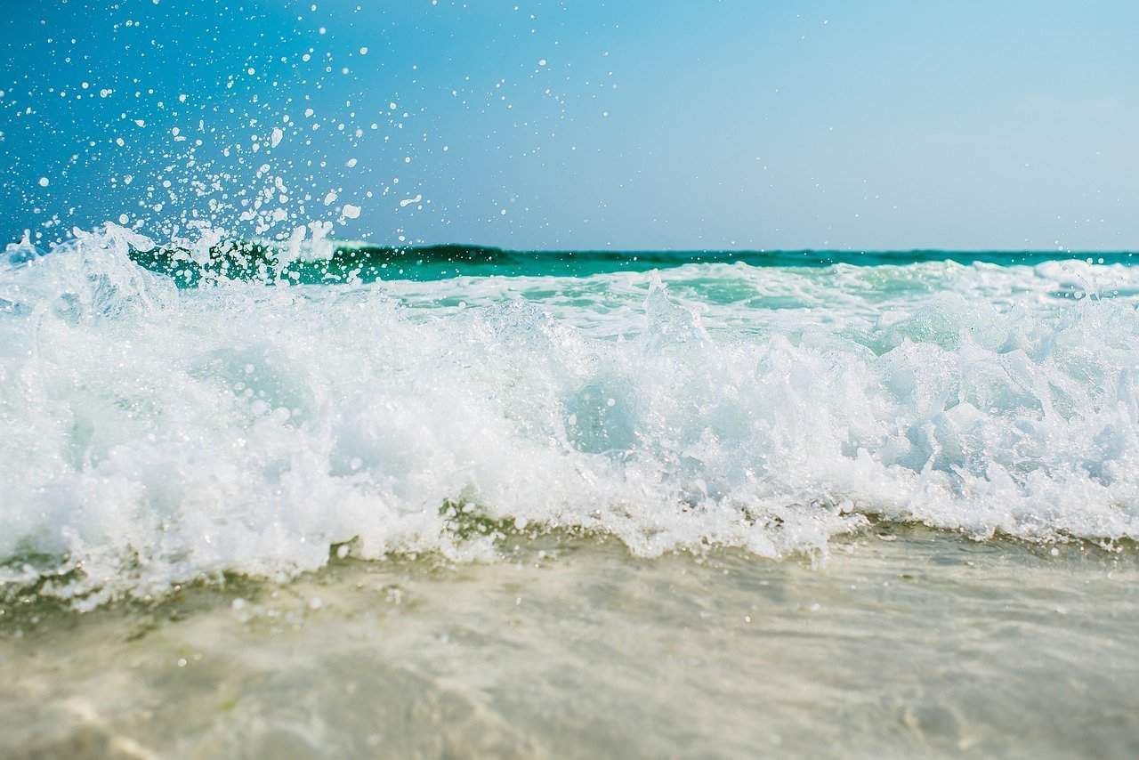 A person riding a wave on a surfboard in the ocean