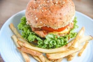 A sandwich with lettuce and fries on a plate