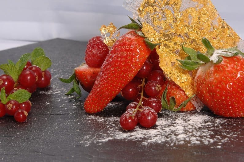 A cake with fruit on top of a table