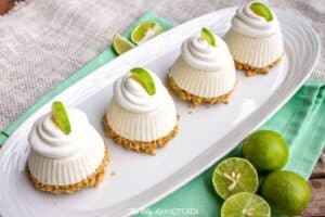 A plate with some cake sitting on top of a table, with Lime and Pie