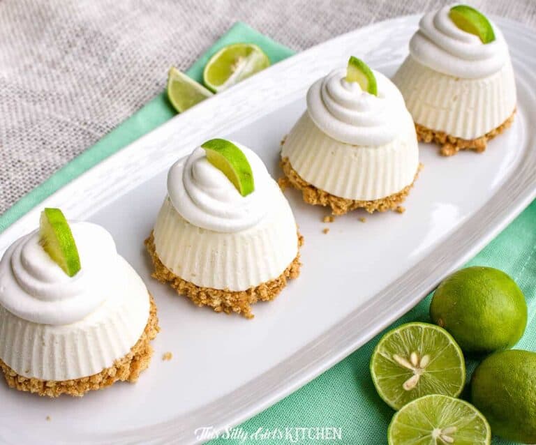 A plate with some cake sitting on top of a table, with Lime and Pie