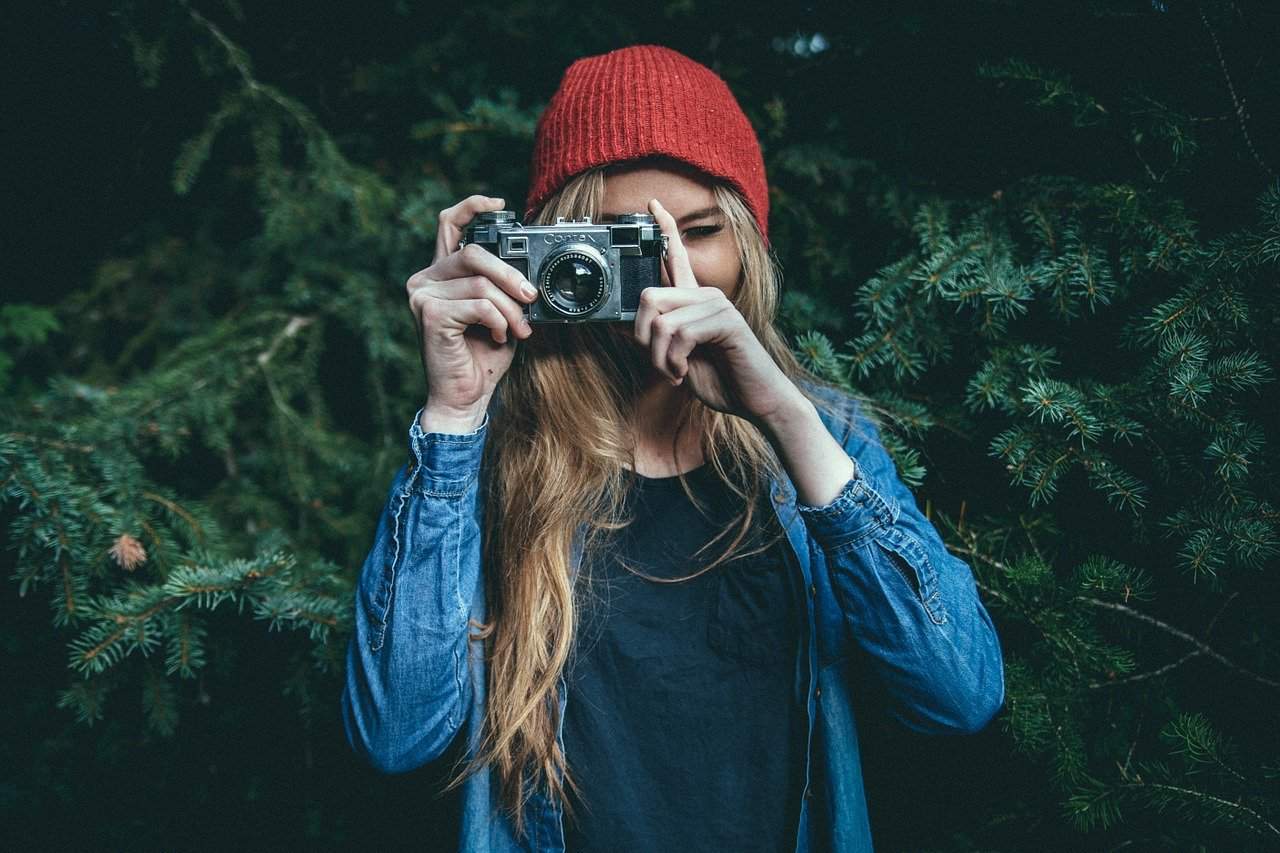 A person wearing a hat talking on a cell phone