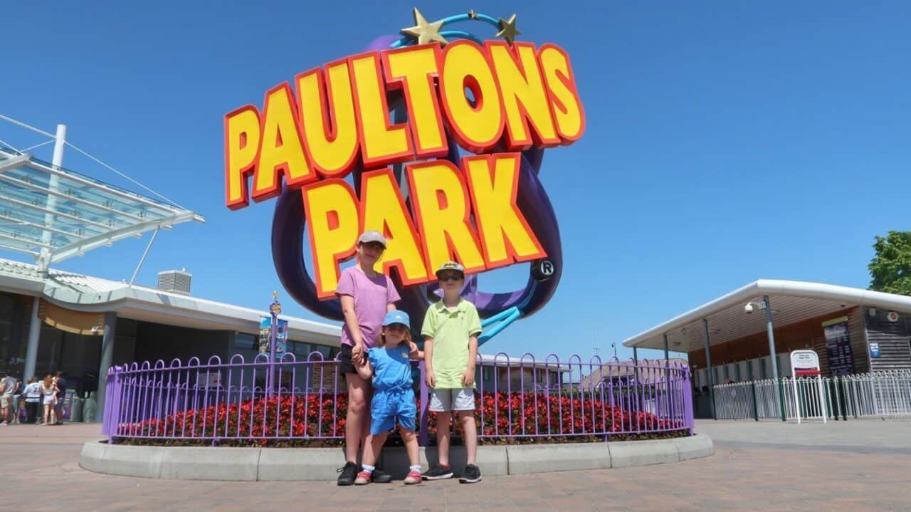 A group of people standing in front of a sign