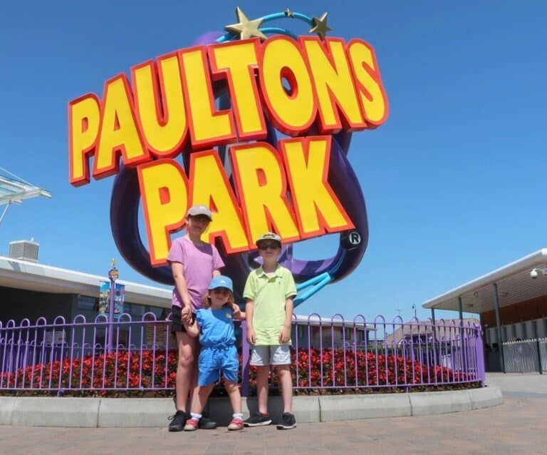 A group of people standing in front of a sign