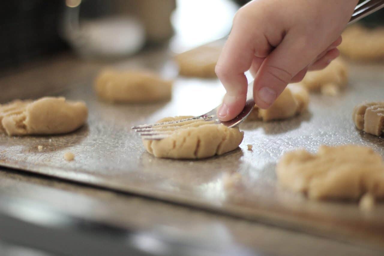 A close up of a person cutting a piece of food