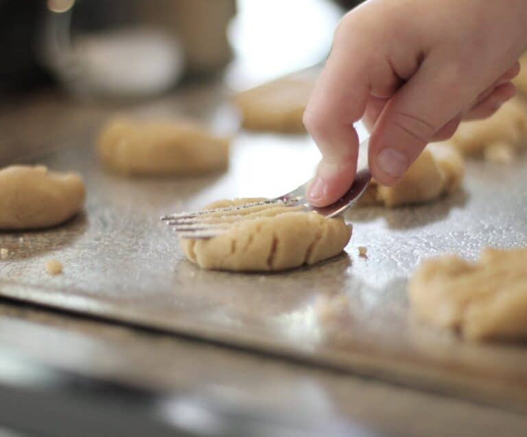 A close up of a person cutting a piece of food