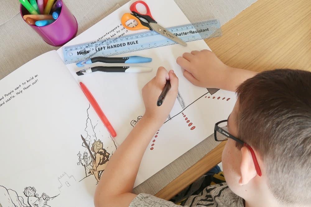 A close up of a person cutting a piece of paper