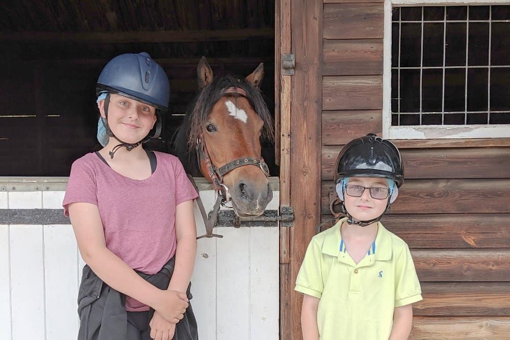 A person standing in front of a horse