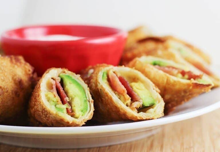 A close up of a plate of food, with Avocado and Bacon