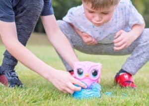 A baby sitting in the grass