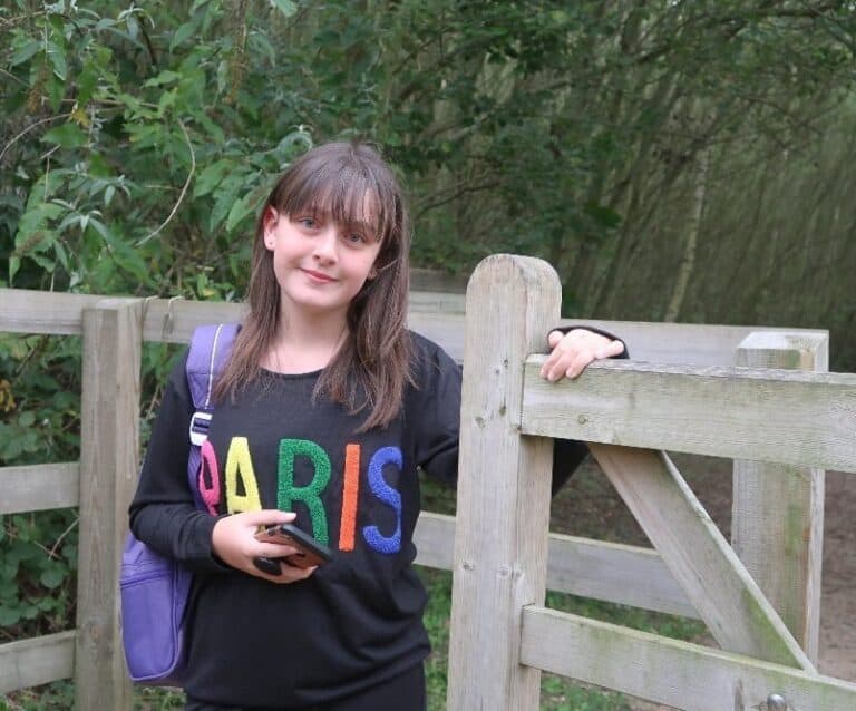 A person sitting on a wooden bench