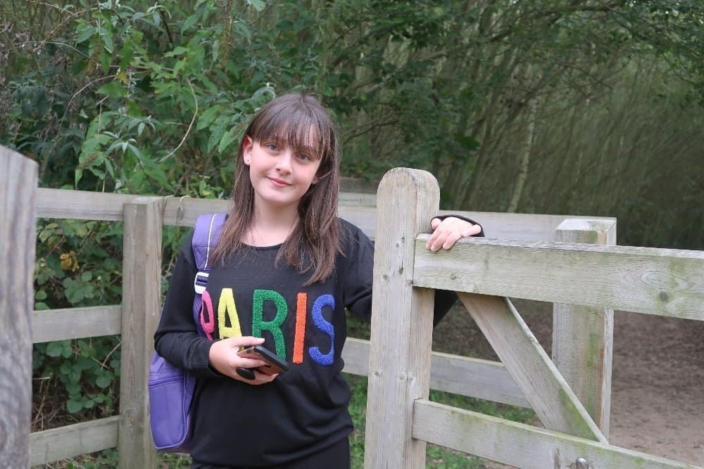 A person sitting on a wooden bench