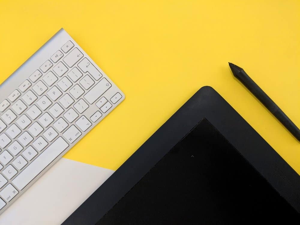 A laptop computer sitting on top of a keyboard