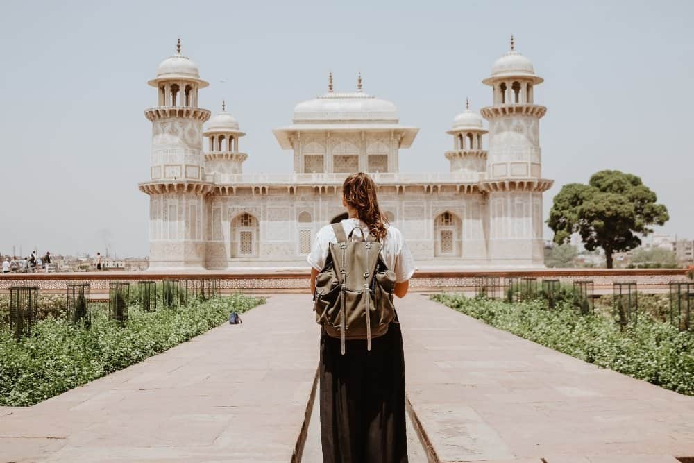 A person standing in front of Tomb of I'timād-ud-Daulah