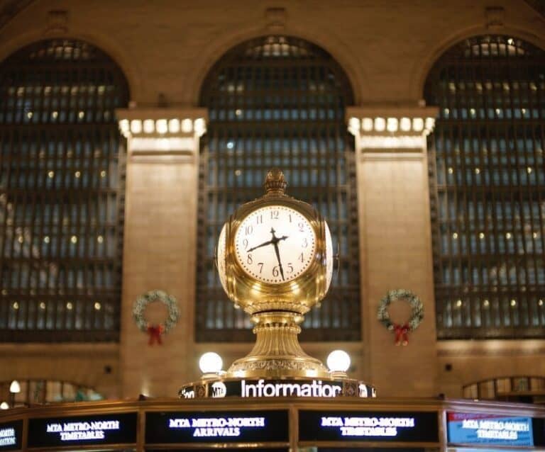 A large clock mounted to the side of a building