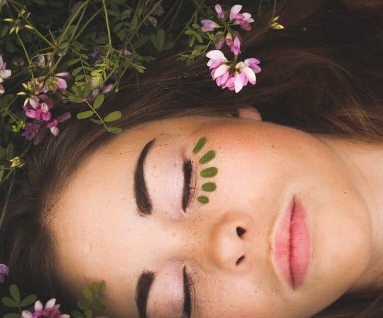 A close up of a person holding a flower